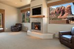 A luxurious bedroom with a gas fireplace, flat screen TV and red rock views from your pilllow
